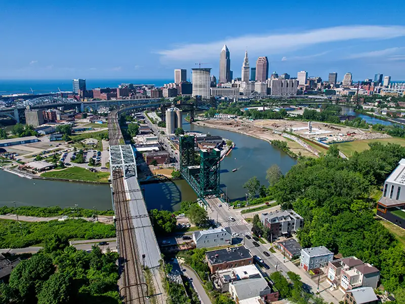 Aerial view of a city skyline with bridges over a river and surrounding buildings.