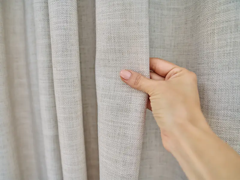 Feeling linen curtain after textile restoration services